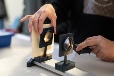 Bilim adamları laboratuvarda optik ve ışık demeti ile çalışırlar.