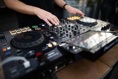 a DJ plays music on a controller at a party