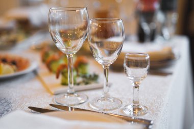 empty goblets and other cutlery are served on the festive table
