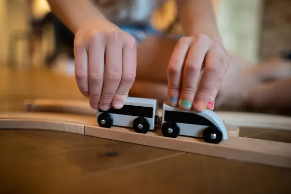 a small child plays with toy cars
