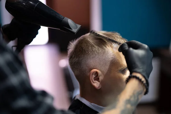 a man gets a haircut and a shave in a barbershop