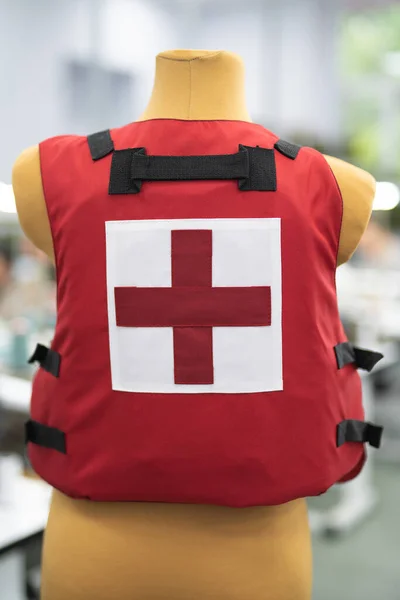 red body armor for medics on a mannequin