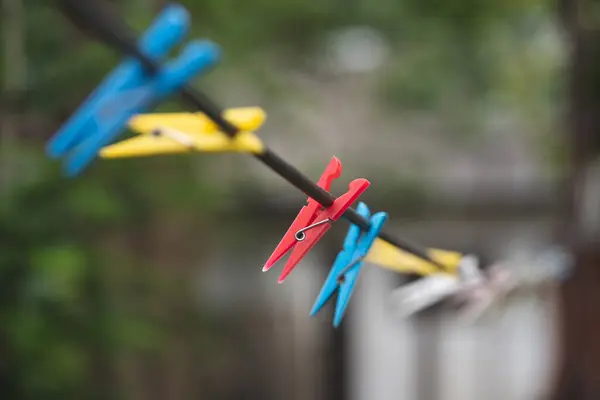 different colors of clothespins for washed clothes on a string