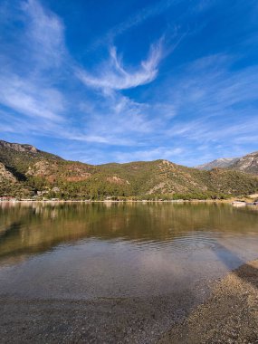 Dağların arka planına karşı gölün güzel manzarası