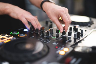 a DJ plays music on a controller at a party