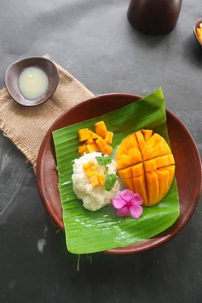 mango sticky rice is Thai dessert made of sticky rice, mango and coconut milk.