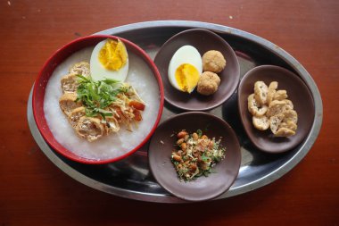 congee porridge with chicken slice, tofu, egg. congee porridge from hong kong. chinese food