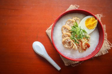 congee porridge with chicken slice, tofu, egg. congee porridge from hong kong. chinese food
