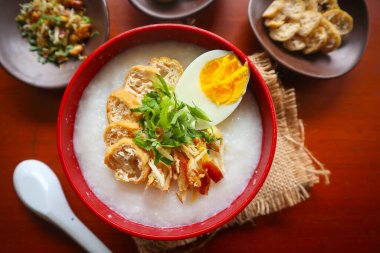 congee porridge with chicken slice, tofu, egg. congee porridge from hong kong. chinese food