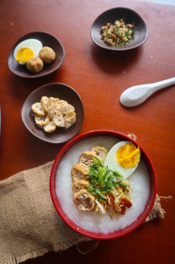 congee porridge with chicken slice, tofu, egg. congee porridge from hong kong. chinese food