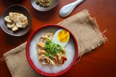 congee porridge with chicken slice, tofu, egg. congee porridge from hong kong. chinese food