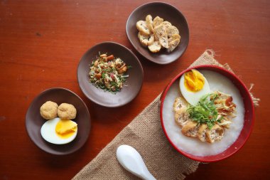 congee porridge with chicken slice, tofu, egg. congee porridge from hong kong. chinese food