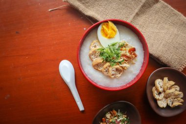 congee porridge with chicken slice, tofu, egg. congee porridge from hong kong. chinese food
