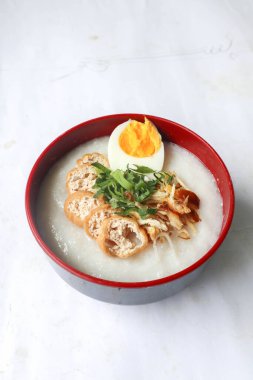 congee porridge with chicken slice, tofu, egg. congee porridge from hong kong. chinese food