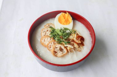 congee porridge with chicken slice, tofu, egg. congee porridge from hong kong. chinese food