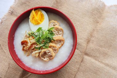 congee porridge with chicken slice, tofu, egg. congee porridge from hong kong. chinese food