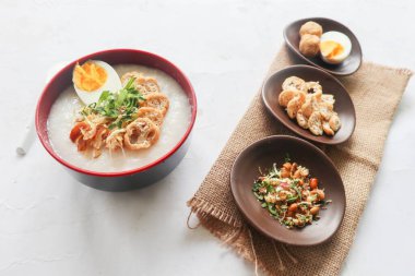 congee porridge with chicken slice, tofu, egg. congee porridge from hong kong. chinese food