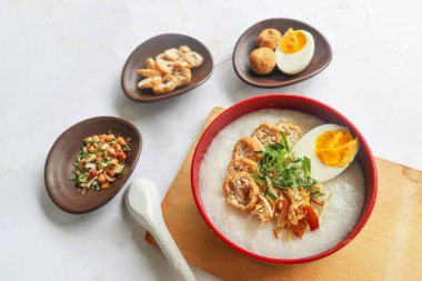 congee porridge with chicken slice, tofu, egg. congee porridge from hong kong. chinese food