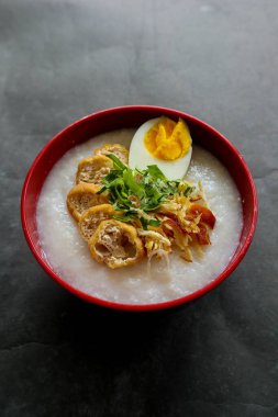 congee porridge with chicken slice, tofu, egg. congee porridge from hong kong. chinese food