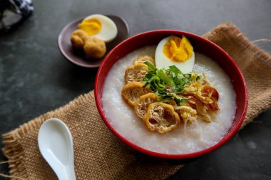 congee porridge with chicken slice, tofu, egg. congee porridge from hong kong. chinese food