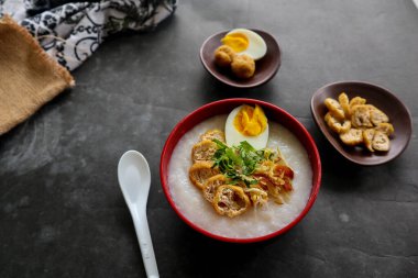 congee porridge with chicken slice, tofu, egg. congee porridge from hong kong. chinese food