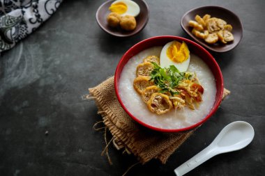 congee porridge with chicken slice, tofu, egg. congee porridge from hong kong. chinese food