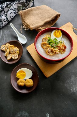congee porridge with chicken slice, tofu, egg. congee porridge from hong kong. chinese food