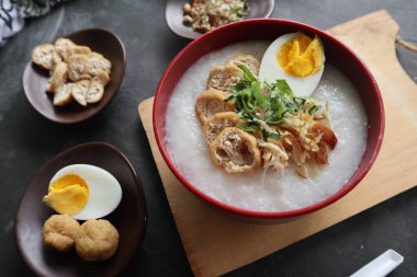 congee porridge with chicken slice, tofu, egg. congee porridge from hong kong. chinese food