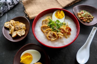 congee porridge with chicken slice, tofu, egg. congee porridge from hong kong. chinese food