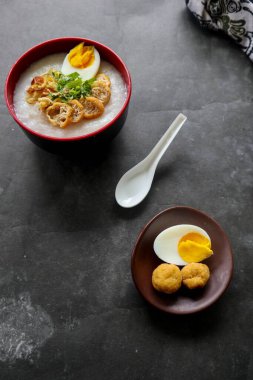 congee porridge with chicken slice, tofu, egg. congee porridge from hong kong. chinese food