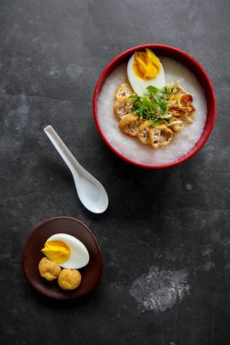 congee porridge with chicken slice, tofu, egg. congee porridge from hong kong. chinese food