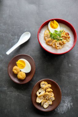 congee porridge with chicken slice, tofu, egg. congee porridge from hong kong. chinese food