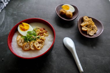 congee porridge with chicken slice, tofu, egg. congee porridge from hong kong. chinese food