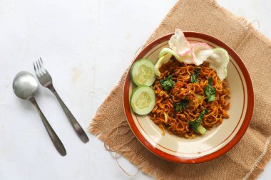 mie tek tek or fried noodle made with egg noodles with chicken, cabbage, mustard greens, meatballs, scrambled eggs. indonesian food