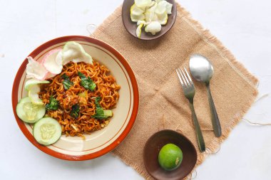 mie tek tek or fried noodle made with egg noodles with chicken, cabbage, mustard greens, meatballs, scrambled eggs. indonesian food