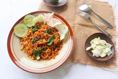 mie tek tek or fried noodle made with egg noodles with chicken, cabbage, mustard greens, meatballs, scrambled eggs. indonesian food