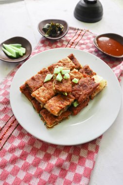 Martabak Telor or Murtabak Telur or mutabbaq. Savory pan-fried pastry stuffed with egg, meat and spices. Martabak Telur is one of Indonesia street food.