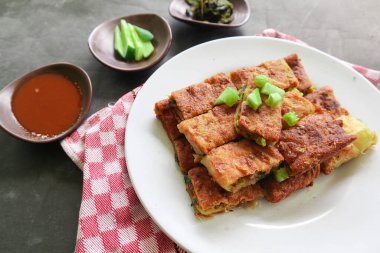 Martabak Telor or Murtabak Telur or mutabbaq. Savory pan-fried pastry stuffed with egg, meat and spices. Martabak Telur is one of Indonesia street food.