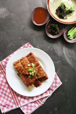 Martabak Telor or Murtabak Telur or mutabbaq. Savory pan-fried pastry stuffed with egg, meat and spices. Martabak Telur is one of Indonesia street food.