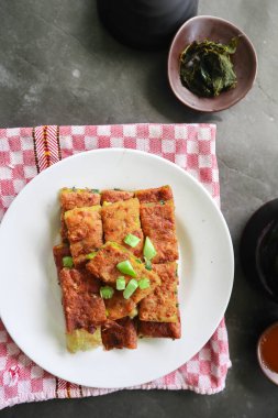 Martabak Telor or Murtabak Telur or mutabbaq. Savory pan-fried pastry stuffed with egg, meat and spices. Martabak Telur is one of Indonesia street food.