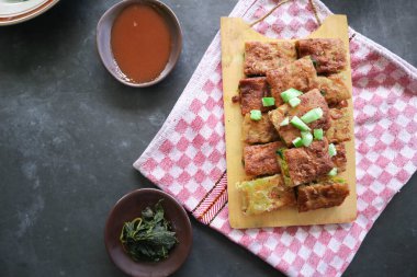 Martabak Telor or Murtabak Telur or mutabbaq. Savory pan-fried pastry stuffed with egg, meat and spices. Martabak Telur is one of Indonesia street food.