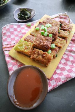 Martabak Telor or Murtabak Telur or mutabbaq. Savory pan-fried pastry stuffed with egg, meat and spices. Martabak Telur is one of Indonesia street food.