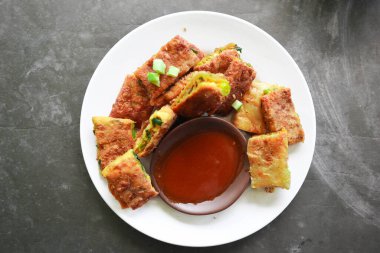 Martabak Telor or Murtabak Telur or mutabbaq. Savory pan-fried pastry stuffed with egg, meat and spices. Martabak Telur is one of Indonesia street food.