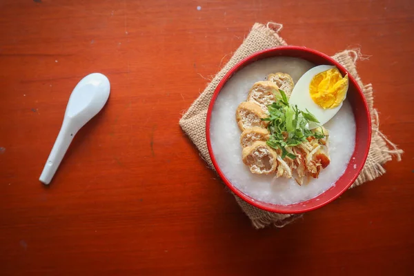 congee porridge with chicken slice, tofu, egg. congee porridge from hong kong. chinese food