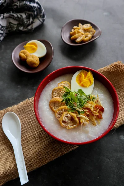 congee porridge with chicken slice, tofu, egg. congee porridge from hong kong. chinese food