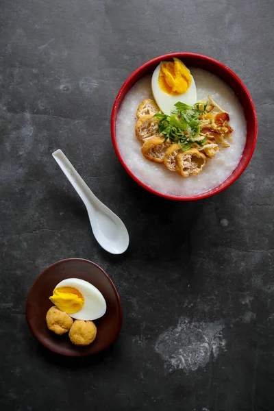 congee porridge with chicken slice, tofu, egg. congee porridge from hong kong. chinese food