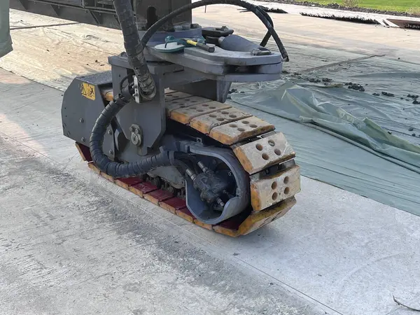 machine. Slipform paver machine on road work at construction site. Highway concrete paving in the new quarter. Repairing concrete roads using new technology