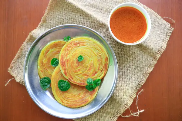 stock image Roti Canai or Paratha Bread with Curry Sauce, Chilli Flakes and Yogurt, on bacakground