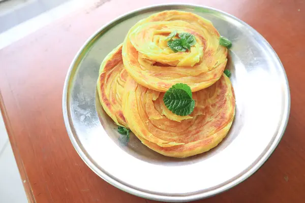 stock image Roti Canai or Paratha Bread with Curry Sauce, Chilli Flakes and Yogurt, on bacakground