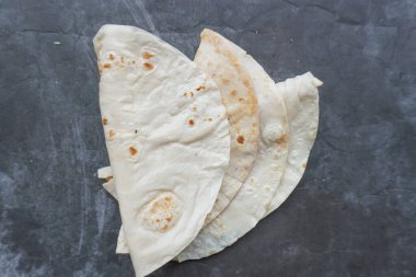 Un Tortilla Paketleri Ev yapımı buğday tortillası, Pita ekmeği, tortilla, masada pişirmek için malzemeli pide. Üst Manzara. Ev yapımı yemek kavramı..